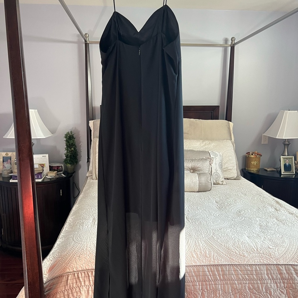 Black dress w/ spaghetti straps & sheer outer layer; shorter layer underneath.